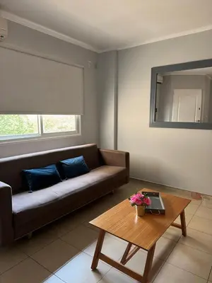 a living room with a couch and a table at Casino Villa Carlos Paz in Villa Carlos Paz