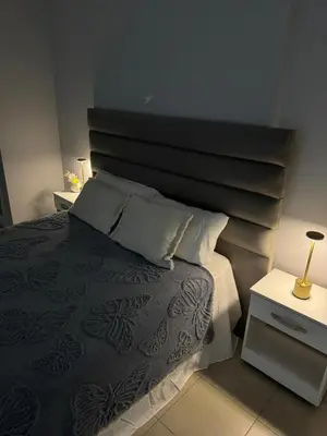 a bedroom with a bed with a large headboard at Casino Villa Carlos Paz in Villa Carlos Paz