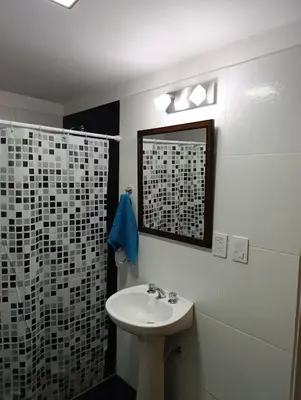 a bathroom with a sink and a shower at Departamento Sinaí Apart in Santa Rosa de Calamuchita