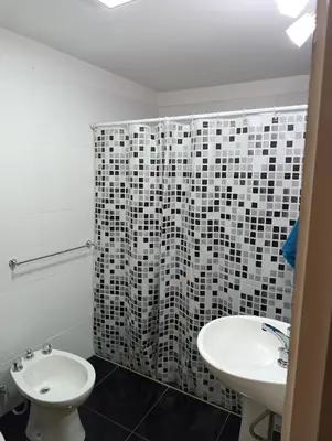a bathroom with a sink and a toilet and a shower at Departamento Sinaí Apart in Santa Rosa de Calamuchita
