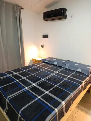a bed in a room with a blue mattress at Departamento Sinaí Apart in Santa Rosa de Calamuchita