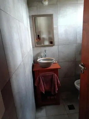 a bathroom with a sink and a mirror at Casa Barrancas del Río Anisacate in Villa Anizacate