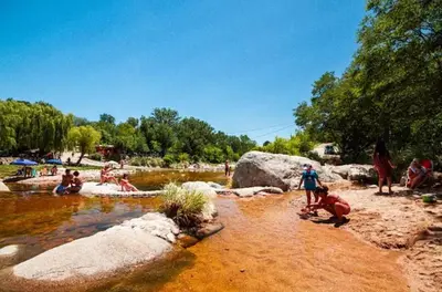 a group of people playing in the water at a park at Las Pircas Apartamentos de Campo in Las Calles