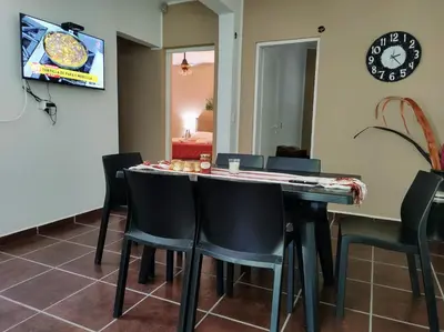 a dining room with a table and chairs at Cabañas El Ceibo in La Bolsa