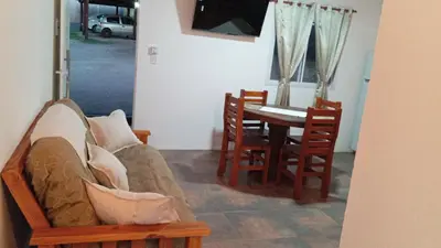 a living room with a couch and a table and chairs at Don Andrés y doña cuca in Merlo