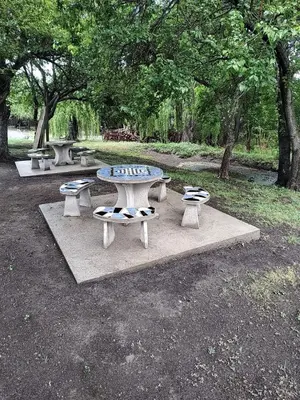 a group of picnic tables in a park at Don Andrés y doña cuca in Merlo