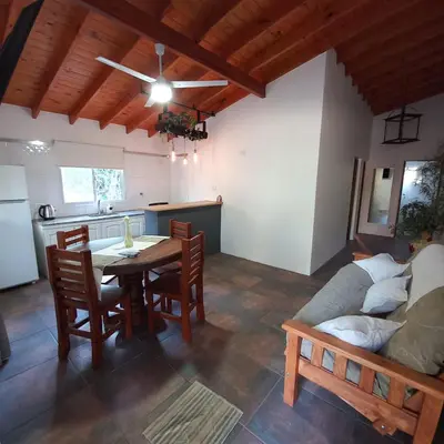a kitchen and living room with a table and a couch at Don Andrés y doña cuca in Merlo