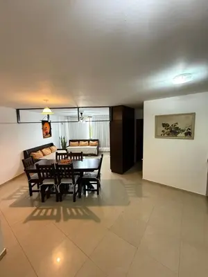 a dining room with a table and chairs and a couch at Dpto amplio con piscina, Excelente ubicación in Villa Carlos Paz