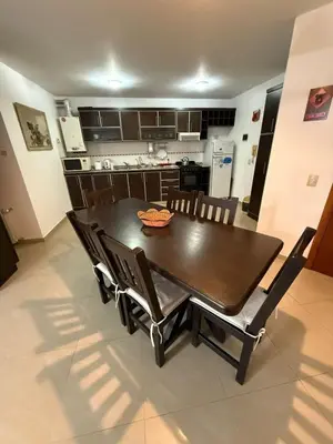 a dining room table and chairs in a kitchen at Dpto amplio con piscina, Excelente ubicación in Villa Carlos Paz