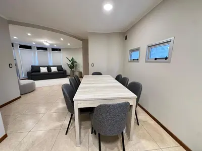 a dining room with a table and chairs at Departamentos Sol y Lago in Villa Carlos Paz