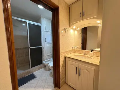 a bathroom with a toilet and a sink and a shower at Departamentos Sol y Lago in Villa Carlos Paz