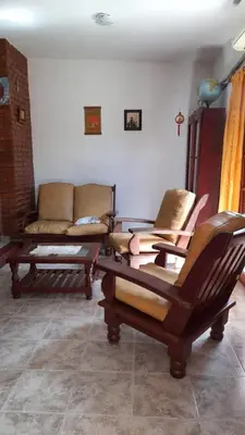 a living room with two chairs and a couch at La casa del pino in Mina Clavero