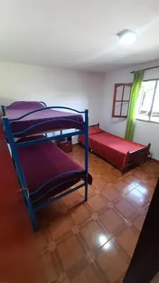 a room with three bunk beds and a window at La casa del pino in Mina Clavero