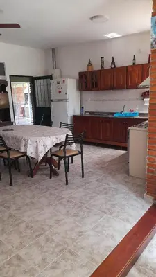 a kitchen with a table and chairs in a room at La casa del pino in Mina Clavero