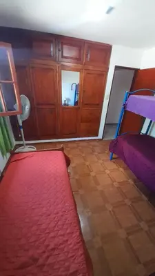 a room with a bed and a red rug at La casa del pino in Mina Clavero