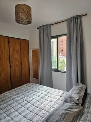 a bedroom with a bed and a window at Luminoso departamento in Cordoba