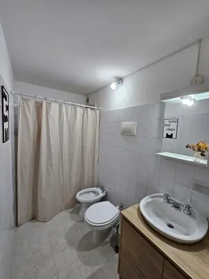 a bathroom with a toilet and a sink at Luminoso departamento in Cordoba