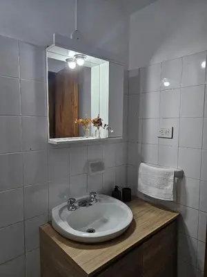 a bathroom with a sink and a mirror at Luminoso departamento in Cordoba