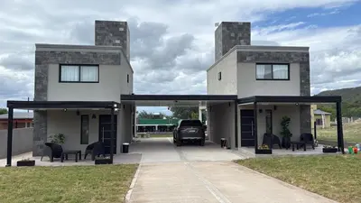 a truck parked in a garage in front of a house at Altos de Las Jarillas in San Antonio de Arredondo