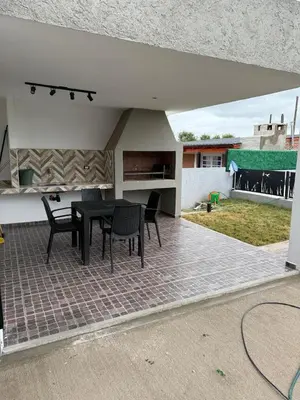 a patio with a black table and chairs on it at Altos de Las Jarillas in San Antonio de Arredondo