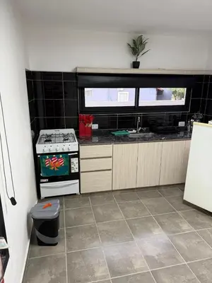 a kitchen with a stove and a sink at Altos de Las Jarillas in San Antonio de Arredondo