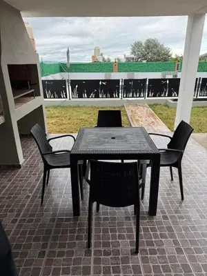 a black table and chairs on a patio at Altos de Las Jarillas in San Antonio de Arredondo