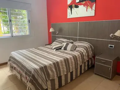 a bedroom with a bed and a red wall at Casa en Nono para 6 personas in Nono