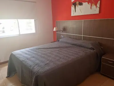 a bedroom with a bed in a red room at Casa en Nono para 6 personas in Nono