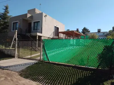 a fence in front of a house at Alojamiento El Pucará in San Antonio de Arredondo
