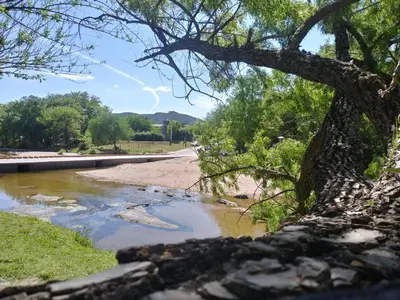 a river on the side of a road at Alojamiento El Pucará in San Antonio de Arredondo