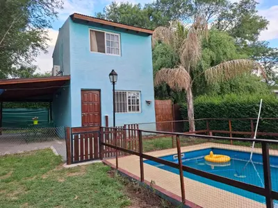 a house with a pool in front of it at Orión VGB in Villa General Belgrano