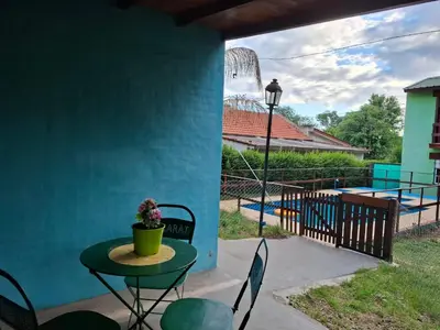 a patio with a table and chairs and a roller coaster at Orión VGB in Villa General Belgrano