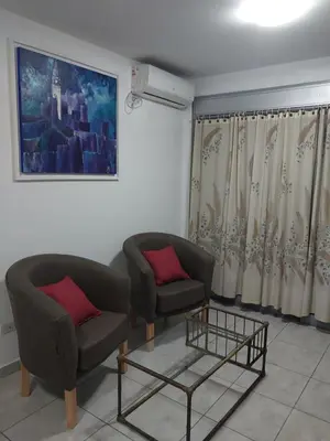 a living room with two chairs and a table at Puesta de Sol in Cordoba