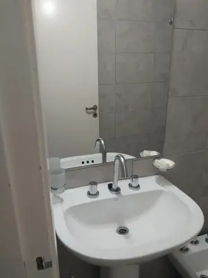 a bathroom with a white sink and a mirror at Puesta de Sol in Cordoba