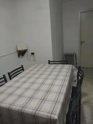 a bed in a room with two chairs and a phone at Puesta de Sol in Cordoba