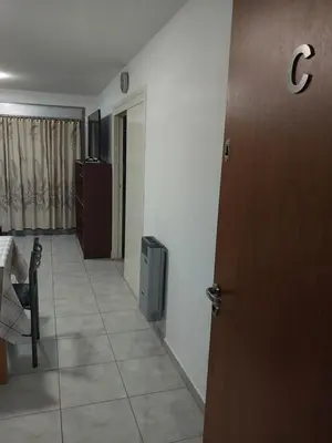 a hallway with a door and a room with a tv at Puesta de Sol in Cordoba