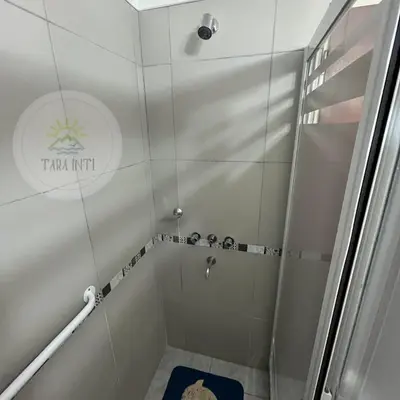 a shower with a glass door in a bathroom at Tara Inti in Merlo