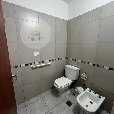 a bathroom with a toilet and a sink at Tara Inti in Merlo