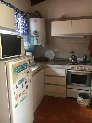 a kitchen with a refrigerator and a stove at Bienvenidos a la Casa de Graciela & Carlos in Villa Carlos Paz