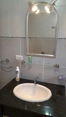 a bathroom with a sink and a mirror on a counter at Habitación doble SOLO PARA DAMAS in Villa General Belgrano