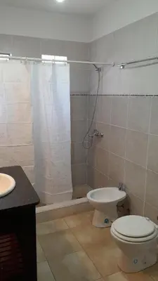 a bathroom with a shower and a toilet and a sink at Habitación doble SOLO PARA DAMAS in Villa General Belgrano