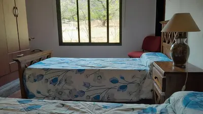 a bedroom with two beds and a window at Habitación doble SOLO PARA DAMAS in Villa General Belgrano