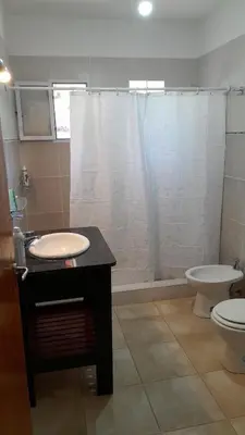 a bathroom with a sink and a toilet and a shower at Habitación doble SOLO PARA DAMAS in Villa General Belgrano