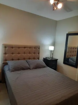 a bedroom with a large bed with a large headboard at Amplio Departamento en Nueva Cordoba in Cordoba