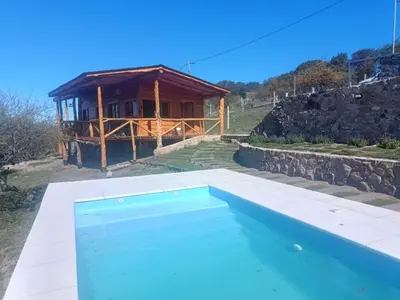 a villa with a pool and a house at Las Piedras in Cuesta Blanca
