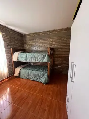 a room with two bunk beds and a wooden floor at El descanso in Villa del Dique