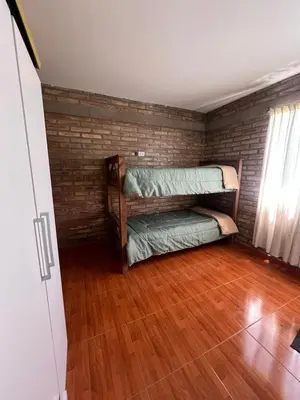 a room with two bunk beds and a wooden floor at El descanso in Villa del Dique