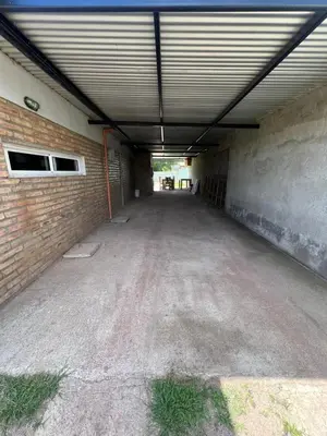 an empty parking garage with a brick wall at El descanso in Villa del Dique