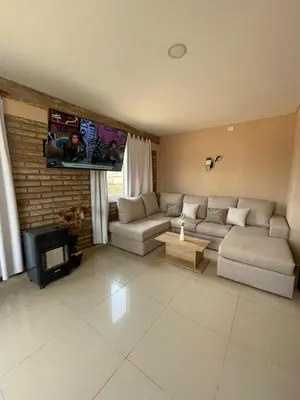 a living room with a couch and a tv at El descanso in Villa del Dique