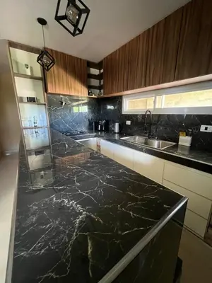 a kitchen with a black marble counter top at El descanso in Villa del Dique